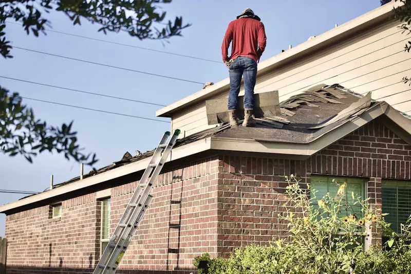 Professional roofer working on a residential roof in Los Ranchos de Albuquerque